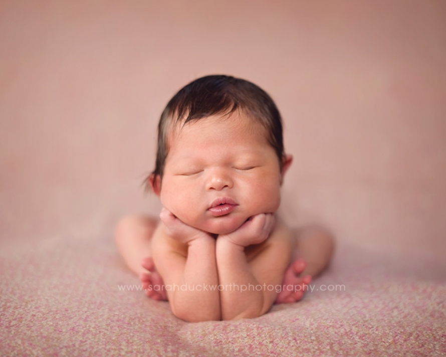 Baby chin on hands newborn